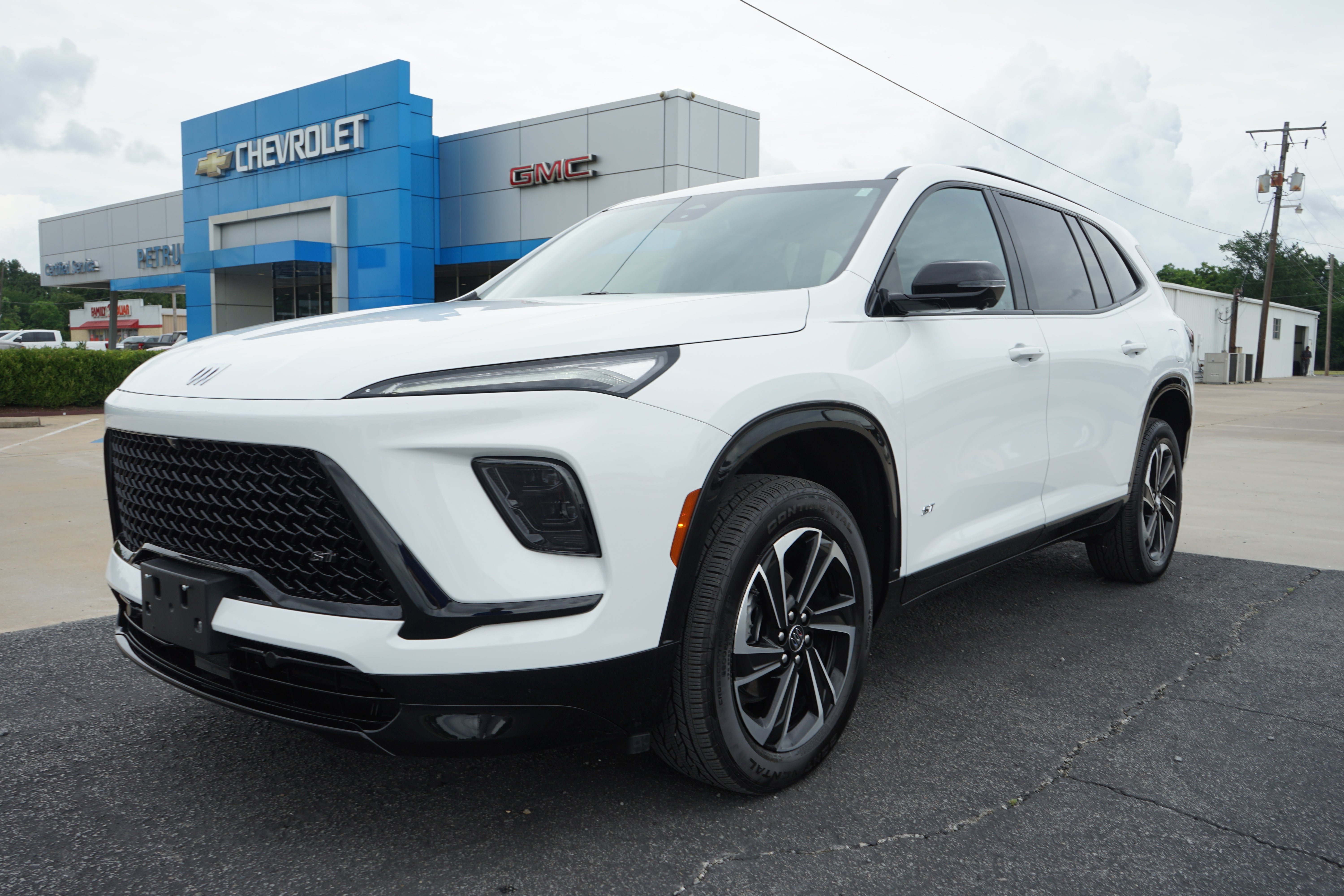 2025 Buick Enclave Sport Touring in Summit White — front three-quarter view